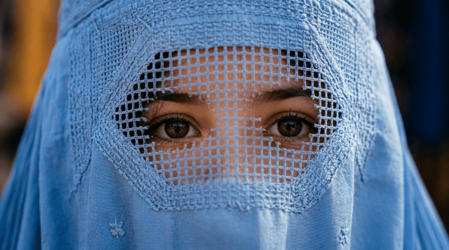 Person in a light blue full-body garment at a busy market